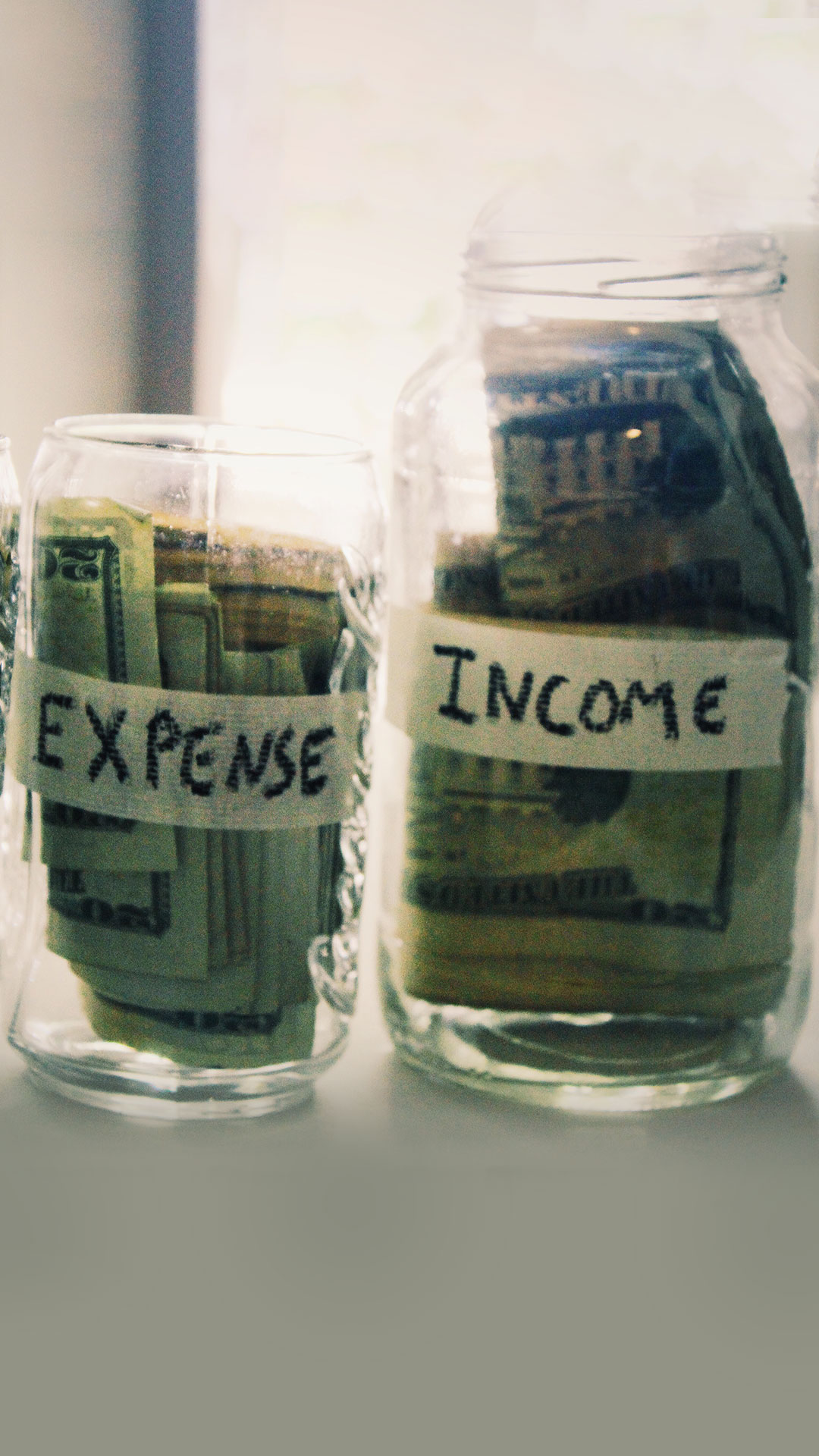 image of jars with money for blog post on the pros and cons of remote, office and hybrid work