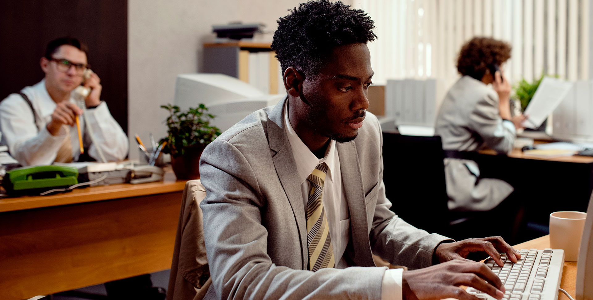 people working in an office  for blog post on the pros and cons of remote, office and hybrid work